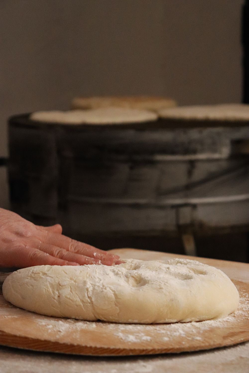 Baker's hands shaping dough